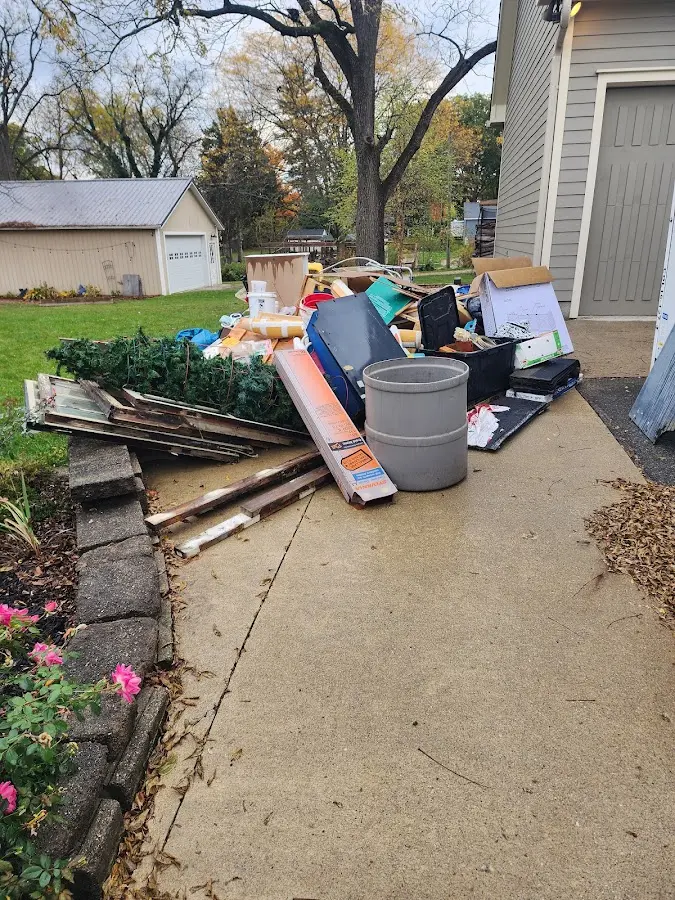 Dumpster being loaded with debris for Residential Dumpster Rental in Bourne